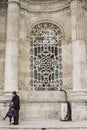 Father and daughter in front of Gothic mosque stained glass.