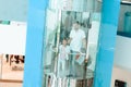 Father and daughter are going down in elevator in shopping mall. Royalty Free Stock Photo