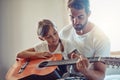 Father with daughter, guitar with teaching and learning at home, bonding with love and creativity. Family, man and girl Royalty Free Stock Photo