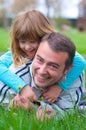 Father and daughter having fun in the grass Royalty Free Stock Photo