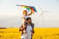 Father and daughter having fun, playing with kite together Royalty Free Stock Photo