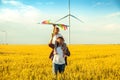 Father and daughter having fun, playing with kite together on the Wheat Field on Bright Summer day Royalty Free Stock Photo