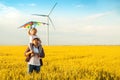 Father and daughter having fun, playing with kite together on the Wheat Field on Bright Summer day Royalty Free Stock Photo