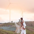 Father and daughter having fun to play in wind turbine Royalty Free Stock Photo