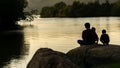 Father daughter His son, sitting on the rocks in the Park