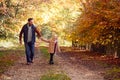 Father And Daughter Holding Hands On Family Walk Along Track In Autumn Countryside Royalty Free Stock Photo