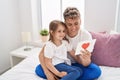 Father and daughter father and daughter hugging each other holding heart draw at bedroom Royalty Free Stock Photo