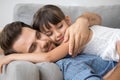 Father and daughter hugging lying on sofa Royalty Free Stock Photo