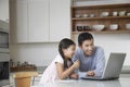 Father And Daughter With Laptop In Kitchen Royalty Free Stock Photo