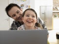 Father And Daughter With Laptop Smiling Together At Home Royalty Free Stock Photo