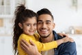 Father Daughter Love. Smiling Arab Dad And Little Girl Embracing At Home