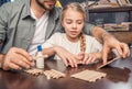 Father and daughter making figure