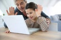 Father and daughter making video call on internet Royalty Free Stock Photo