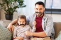 Father and daughter with mustaches having fun