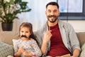 Father and daughter with mustaches having fun