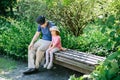 Father with daughter on natural parkland talking on bench Royalty Free Stock Photo