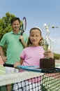 Father and Daughter by net on tennis court Royalty Free Stock Photo