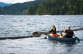 Father and daughter with oars went fishing with husky dog rowing in kayak on the waves of Lake Merwin in Washington Royalty Free Stock Photo