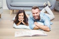 Father and daughter with picture book on floor Royalty Free Stock Photo