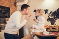 Father and daughter play, cook and eat Christmas cookies and muffins in the loft-style kitchen