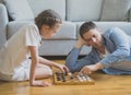 Family playing checkers board game. Royalty Free Stock Photo