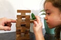 Father and daughter playing game Tumble tower from wooden block together Royalty Free Stock Photo