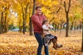 Father and daughter are playing and having fun in autumn city park. They posing, smiling, playing. Bright yellow trees. Royalty Free Stock Photo