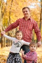 Father and daughter are playing and having fun in autumn city park. They posing, smiling, playing. Bright yellow trees Royalty Free Stock Photo