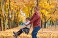 Father and daughter are playing and having fun in autumn city park. They posing, smiling, playing. Bright yellow trees Royalty Free Stock Photo