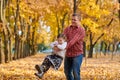 Father and daughter are playing and having fun in autumn city park. They posing, smiling, playing. Bright yellow trees Royalty Free Stock Photo