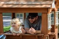 Father and daughter playing in playhouse in backyard Royalty Free Stock Photo