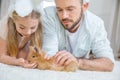 Father and daughter playing with rabbit Royalty Free Stock Photo