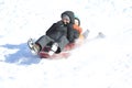 Father and daughter playing in snow sledding, New England, US