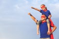 Father and daughter playing superhero at the day time.