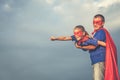 Father and daughter playing superhero outdoors at the day time. Royalty Free Stock Photo