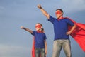 Father and daughter playing superhero outdoors at the day time. Royalty Free Stock Photo