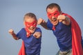 Father and daughter playing superhero outdoors at the day time. Royalty Free Stock Photo