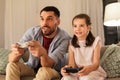 Father and daughter playing video game at home Royalty Free Stock Photo