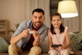 Father and daughter playing video game at home Royalty Free Stock Photo