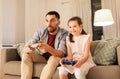 Father and daughter playing video game at home Royalty Free Stock Photo