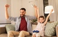 Father and daughter playing video game at home Royalty Free Stock Photo