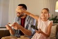 Father and daughter playing video game at home Royalty Free Stock Photo