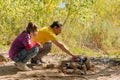 Father and daughter preparing dinner over fire Royalty Free Stock Photo