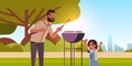 Father and daughter preparing hot dogs on grill happy family having fun picnic barbecue party concept summer park Royalty Free Stock Photo