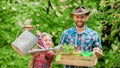 Father and daughter on ranch. little girl and happy man dad. earth day. spring village country. ecology. Watering can Royalty Free Stock Photo