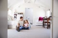 Father and daughter reading a book together in her bedroom Royalty Free Stock Photo