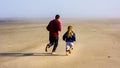 Father and Daughter Run on empty beach sand Royalty Free Stock Photo