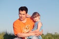 Father and daughter sitting in green meadow Royalty Free Stock Photo