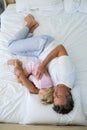 Father and daughter sleeping together on bed in bedroom Royalty Free Stock Photo