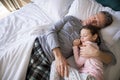 Father and daughter sleeping together on bed in bedroom Royalty Free Stock Photo